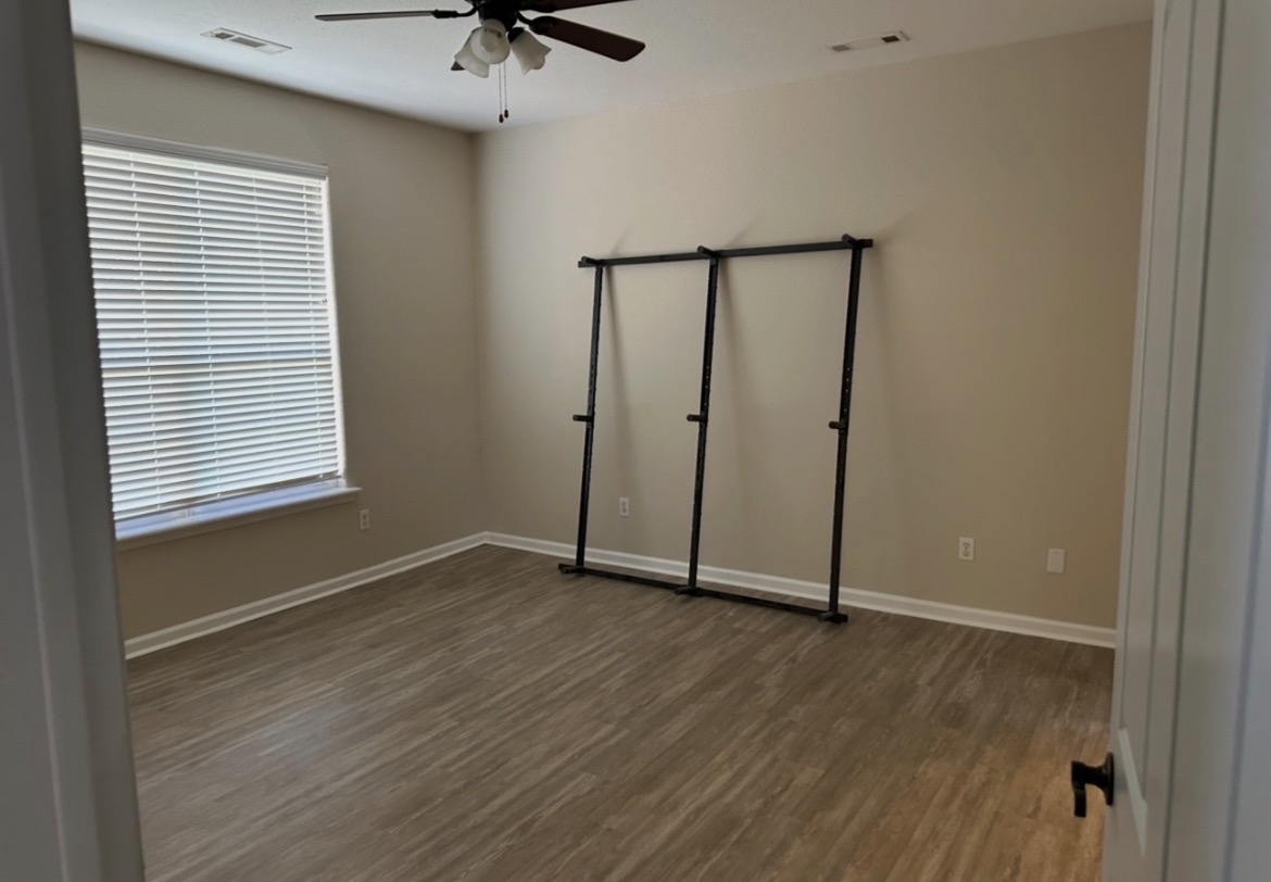 Room with newly installed wood-look plank flooring and freshly painted neutral walls